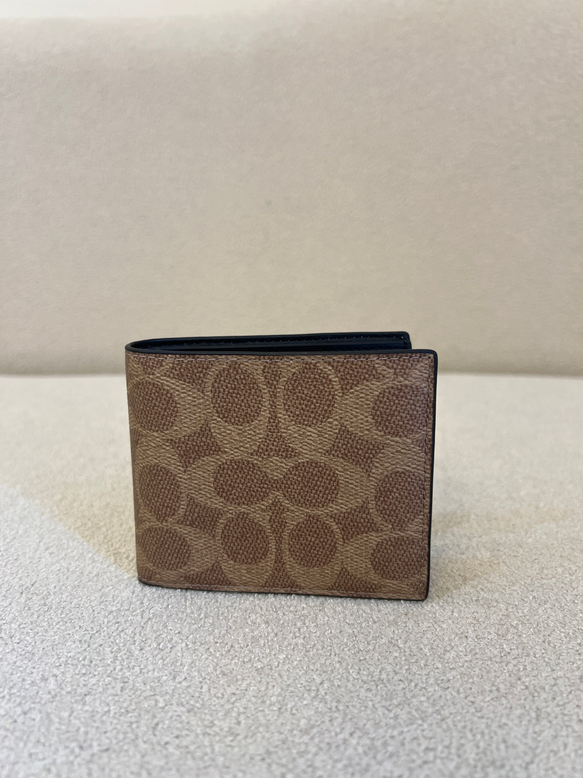 Coach ID Billfold Wallet in Signature Canvas, often found in Tan/Black or Mahogany