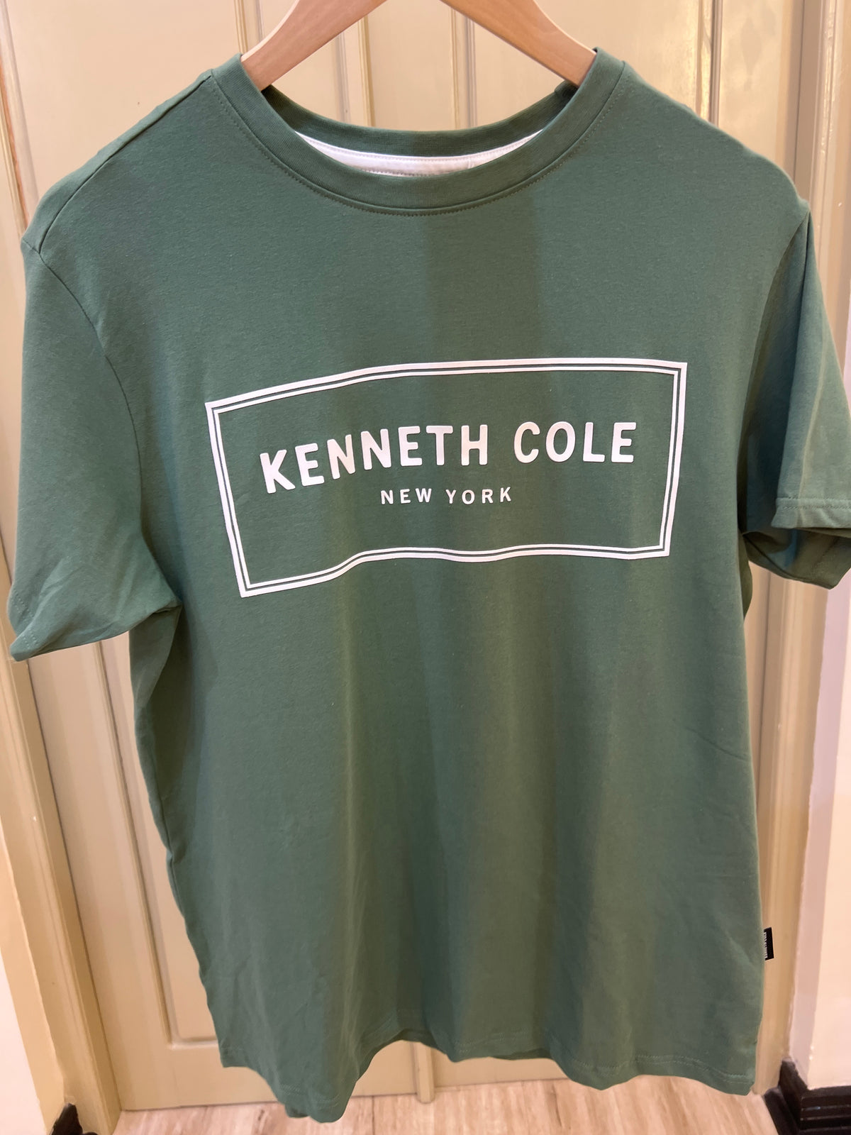 Kenneth Cole New York graphic T-shirt featuring a green color and a prominent white branded box logo