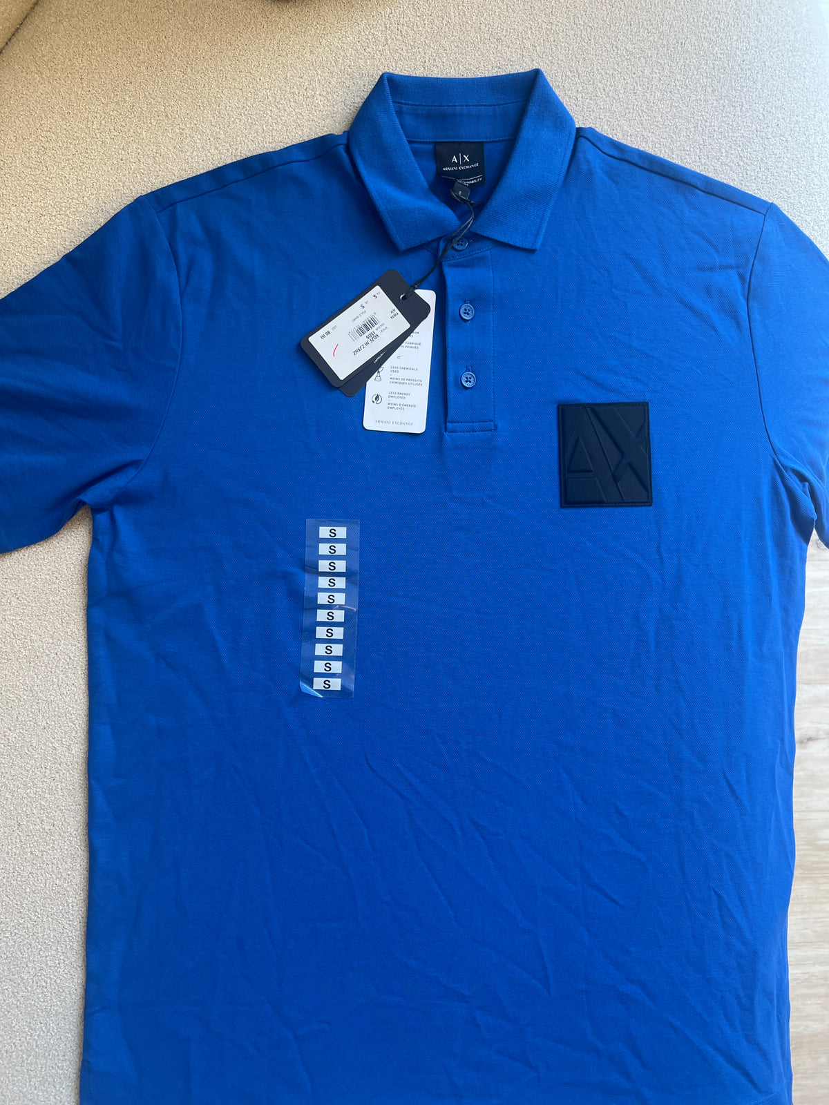 The Armani Exchange ASV Organic Cotton Regular Fit Polo with Logo is a blue men's polo shirt featuring an embossed logo patch