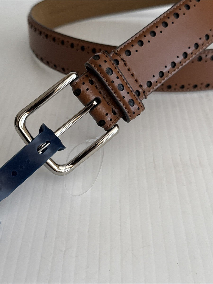 Cole Haan men's perforated leather belt is a tan-colored accessory featuring a polished silver buckle