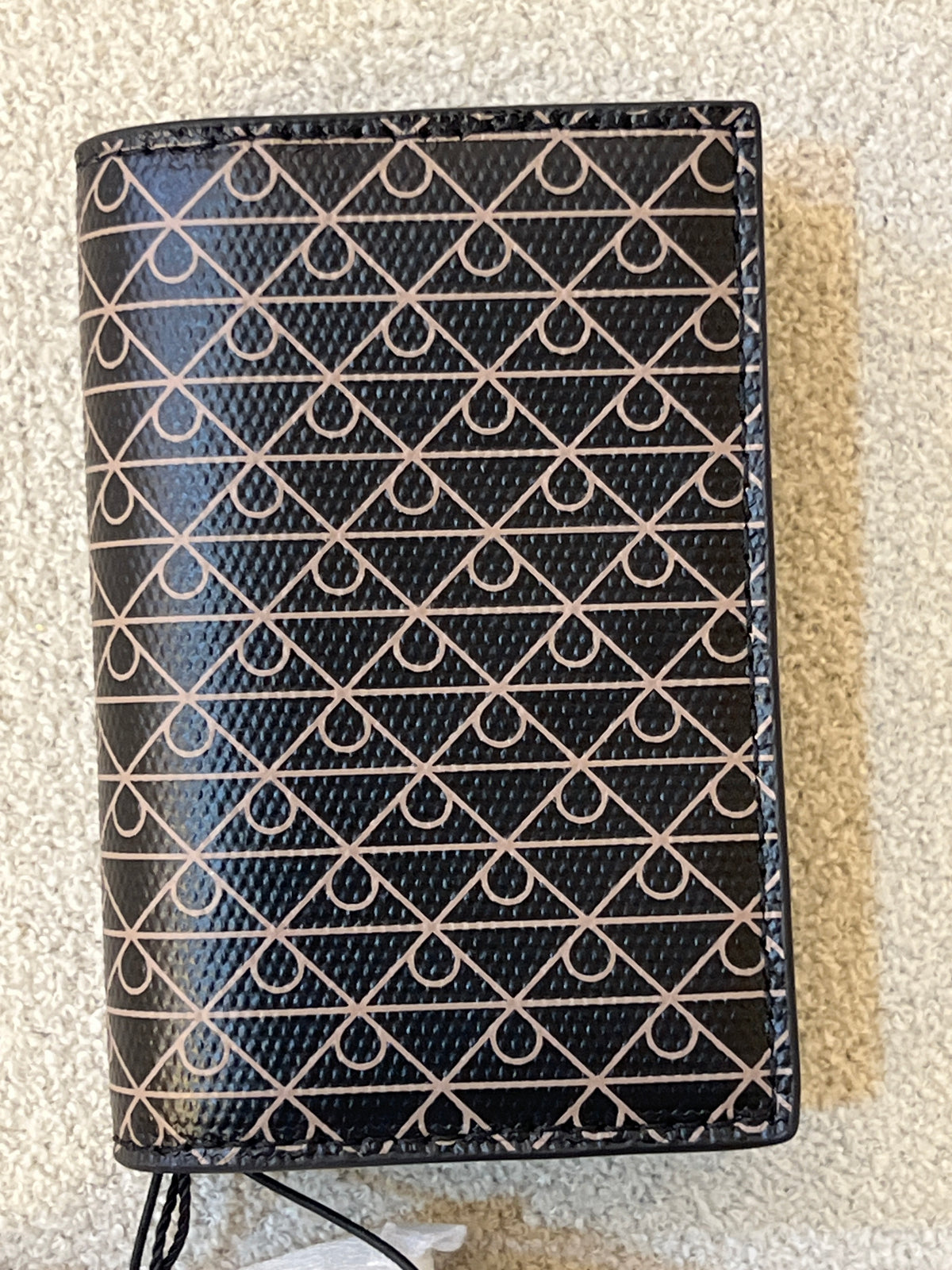 Calvin Klein wallet features a signature monogram logo motif pattern