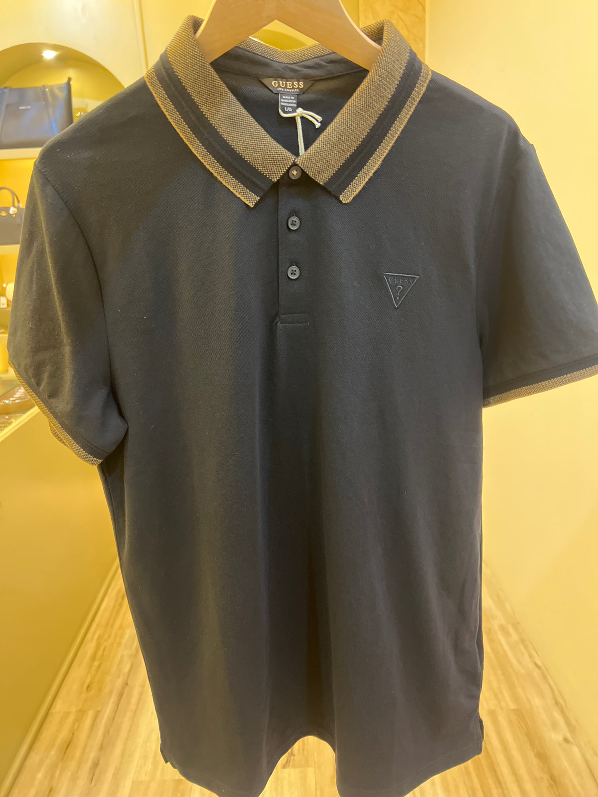 GUESS Men's Lyle Short Sleeve Polo is made from a blend of cotton and elastane, featuring a collared neck, button placket, and ribbed cuffs