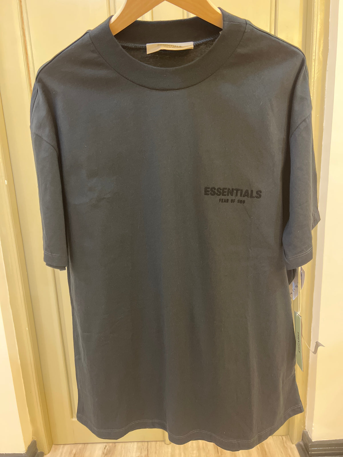 Fear of God Essentials Stretch Limo Black t-shirt features a subtle, flocked logo on the chest