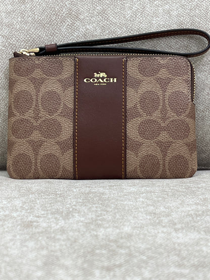 Coach Corner Zip Wristlet in signature canvas with a brown leather stripe