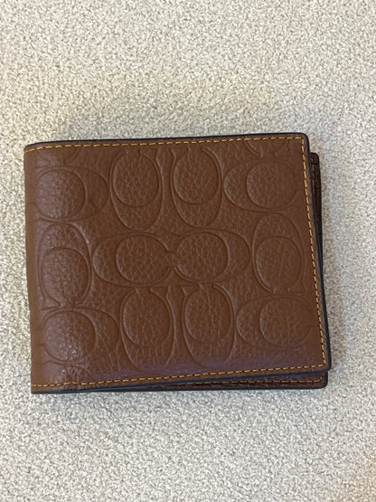 Coach 3-in-1 wallet is crafted from signature crossgrain leather with a brown embossed design