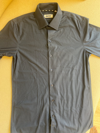 DKNY men's dress shirt is featured in a deep navy blue with a subtle textured pattern