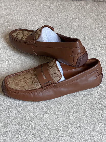 Coach men's loafers are the Liam Driver model, featuring a distinctive signature jacquard canvas panel contrasted with solid leather
