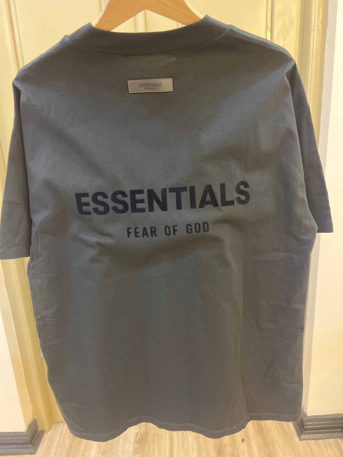 Fear of God Essentials Stretch Limo Black t-shirt features a subtle, flocked logo on the chest