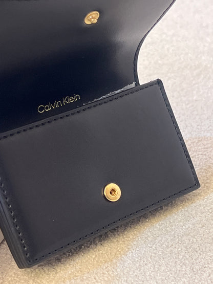 Calvin Klein wallet features a signature monogram logo motif pattern