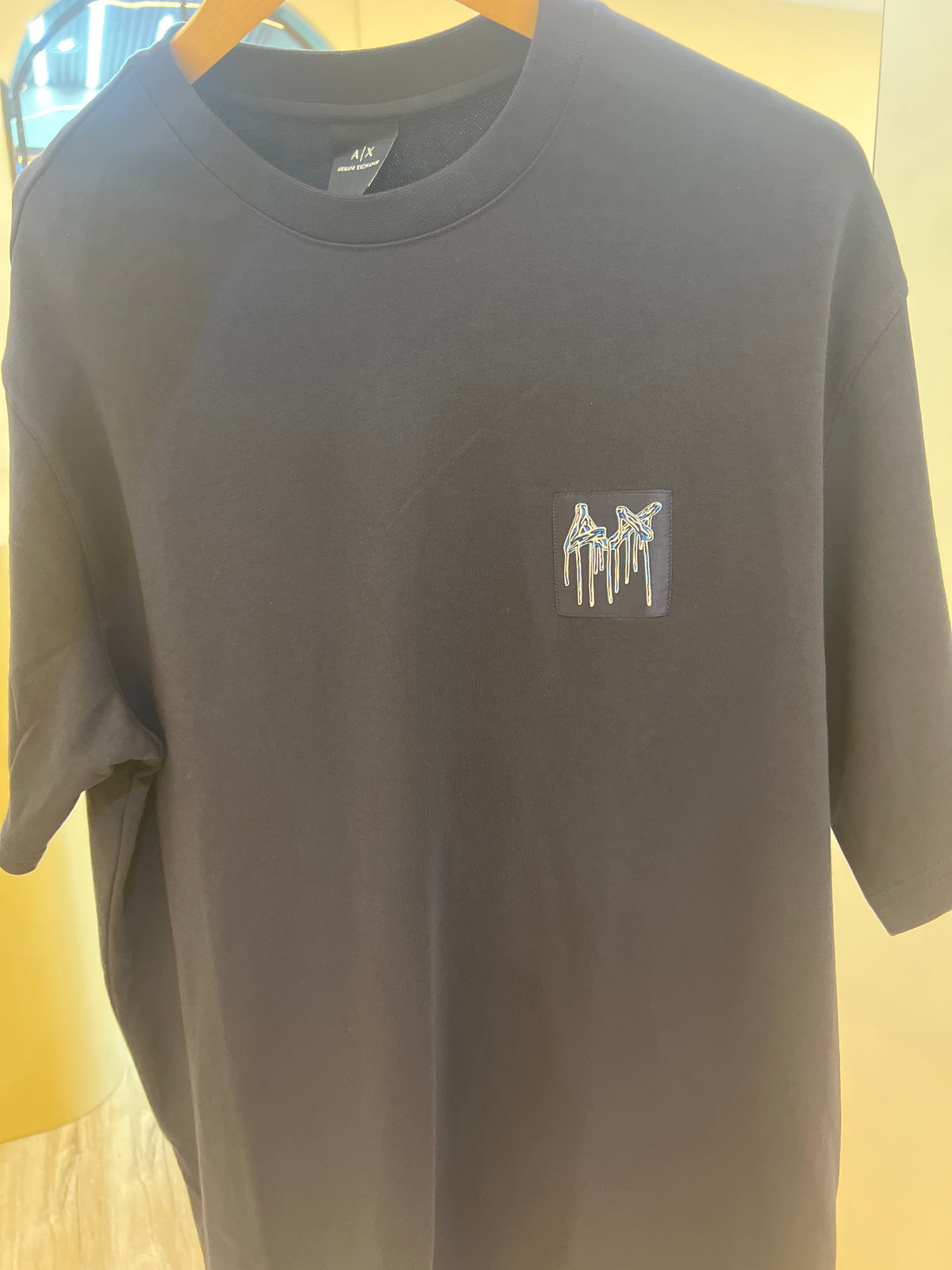 Armani Exchange crew neck t-shirt featuring a distinctive graphic logo on the chest back print graphic t-shirt featuring a stylized "1991" design Navy blue