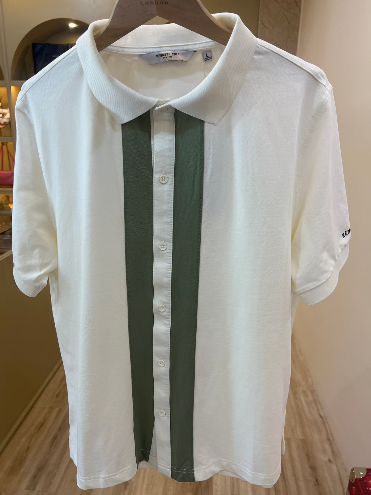 Kenneth Cole New York white polo shirt featuring olive green vertical stripe detailing