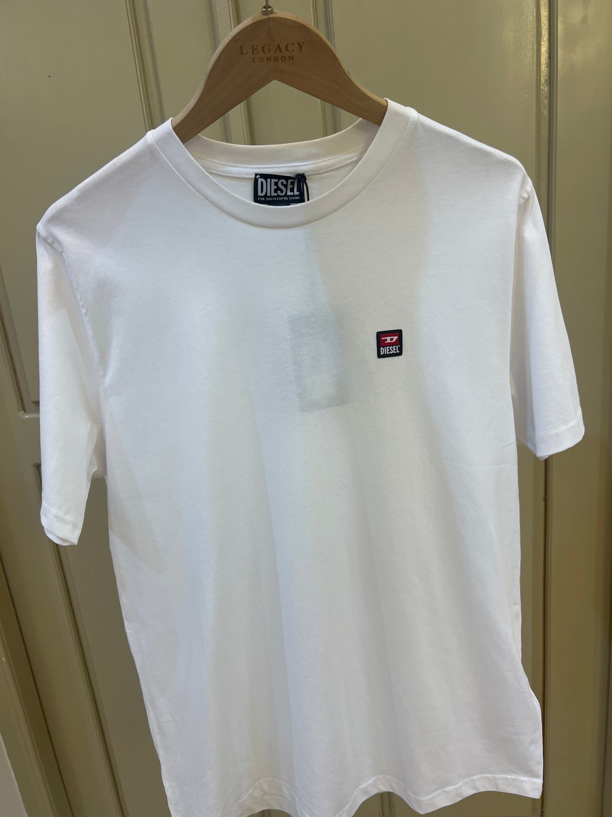 Diesel T-shirt features a small, red, white, and black jacquard logo patch on the chest