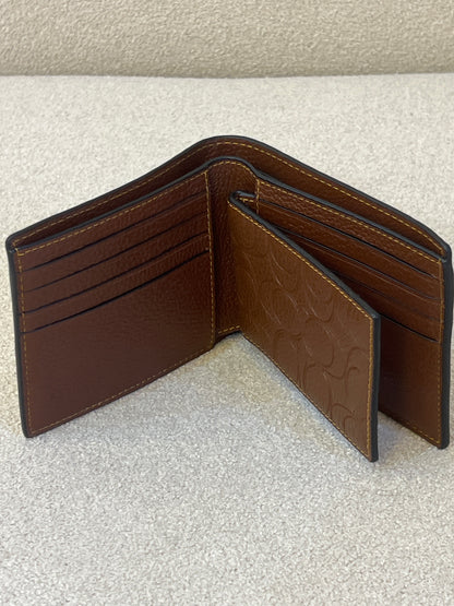 Coach 3-in-1 wallet is crafted from signature crossgrain leather with a brown embossed design