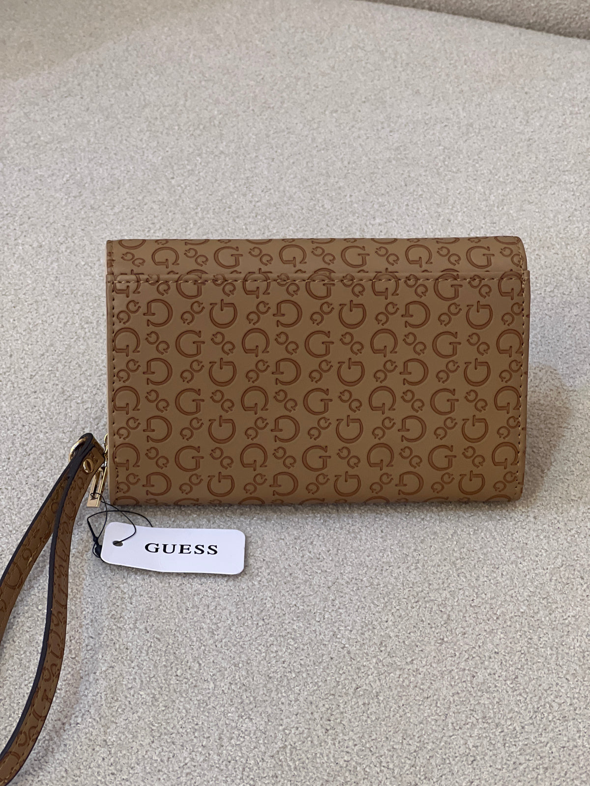 Guess Julie Phone Organizer Wallet, a brown faux-leather wristlet featuring an allover logo print and a gold-tone triangle logo on the front