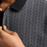 Armani Exchange men's polo shirt with a black collar and a light grey/silver all-over pattern