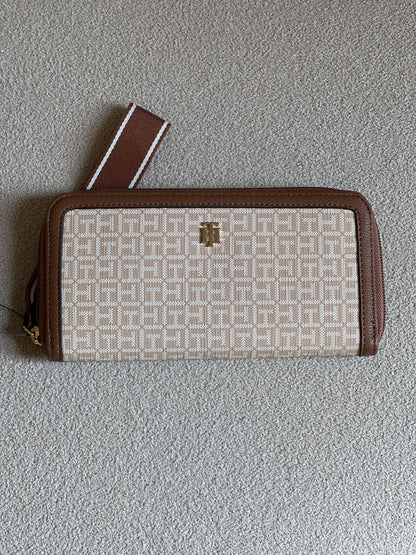 Tommy Hilfiger monogram jacquard zip-around wallet features a classic beige pattern with brown trim