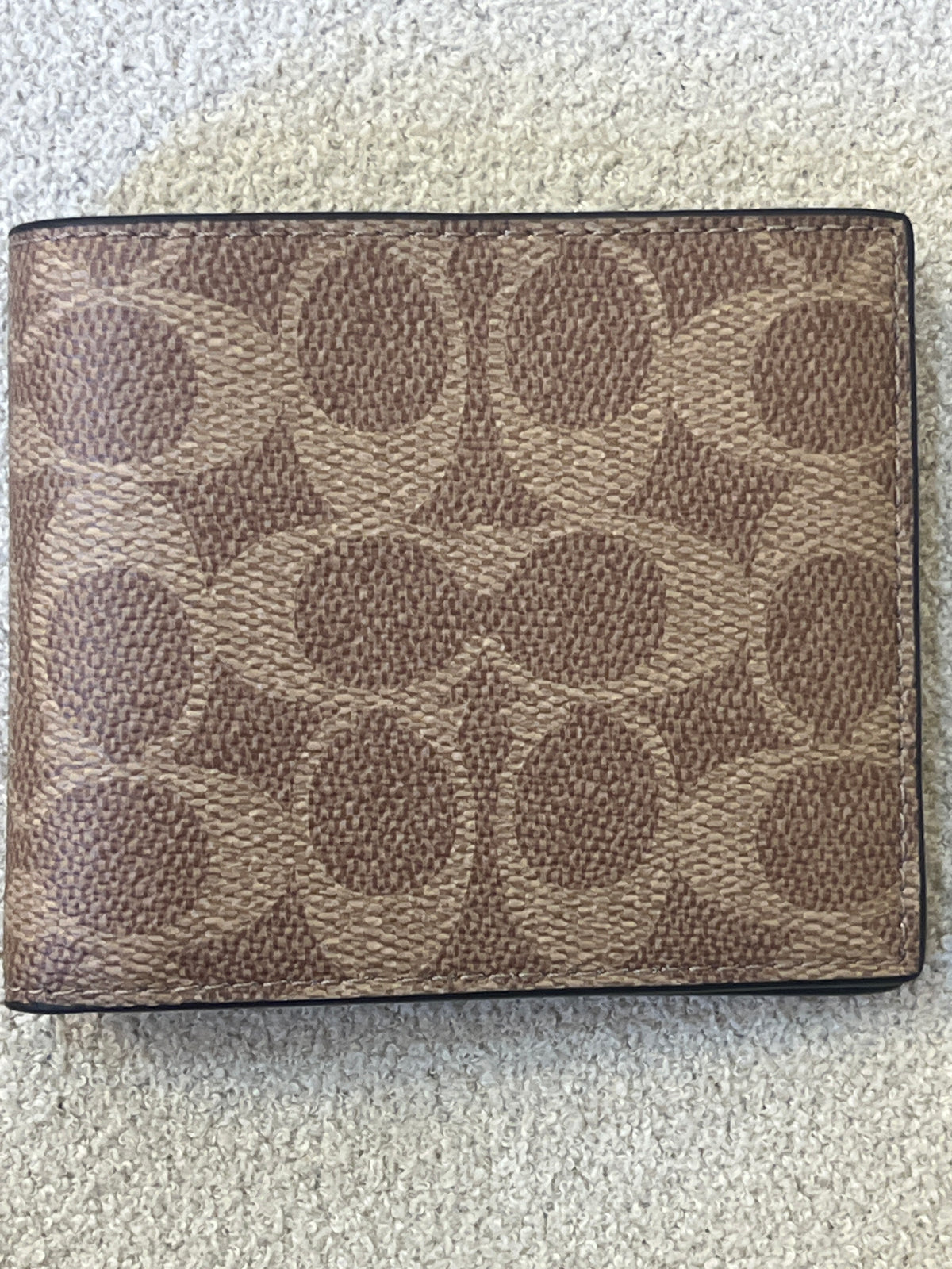Coach ID Billfold Wallet in Signature Canvas, often found in Tan/Black or Mahogany