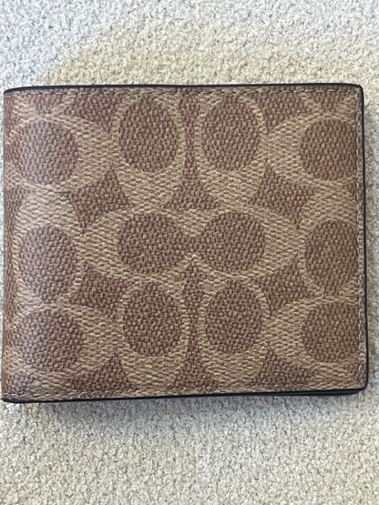 Coach ID Billfold Wallet in Signature Canvas, often found in Tan/Black or Mahogany