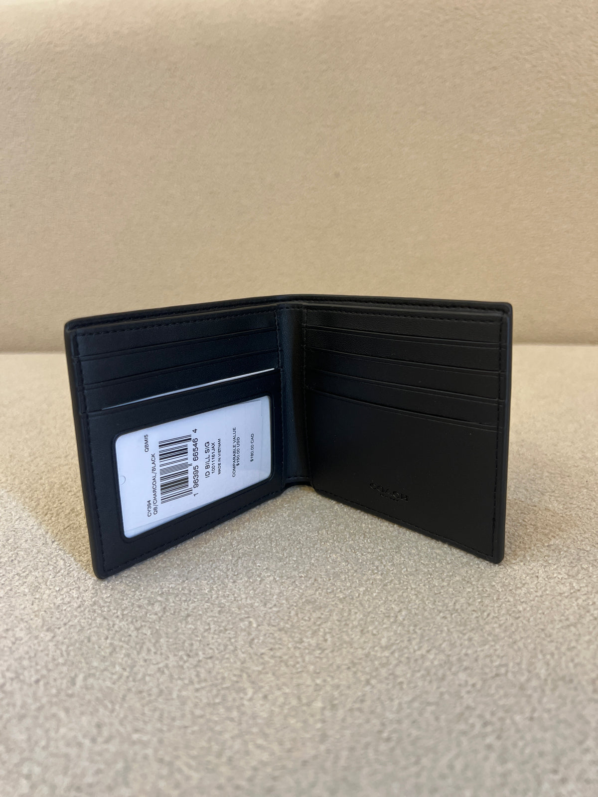 Appears to be a Coach Men's 3-in-1 Wallet in Signature Canvas.