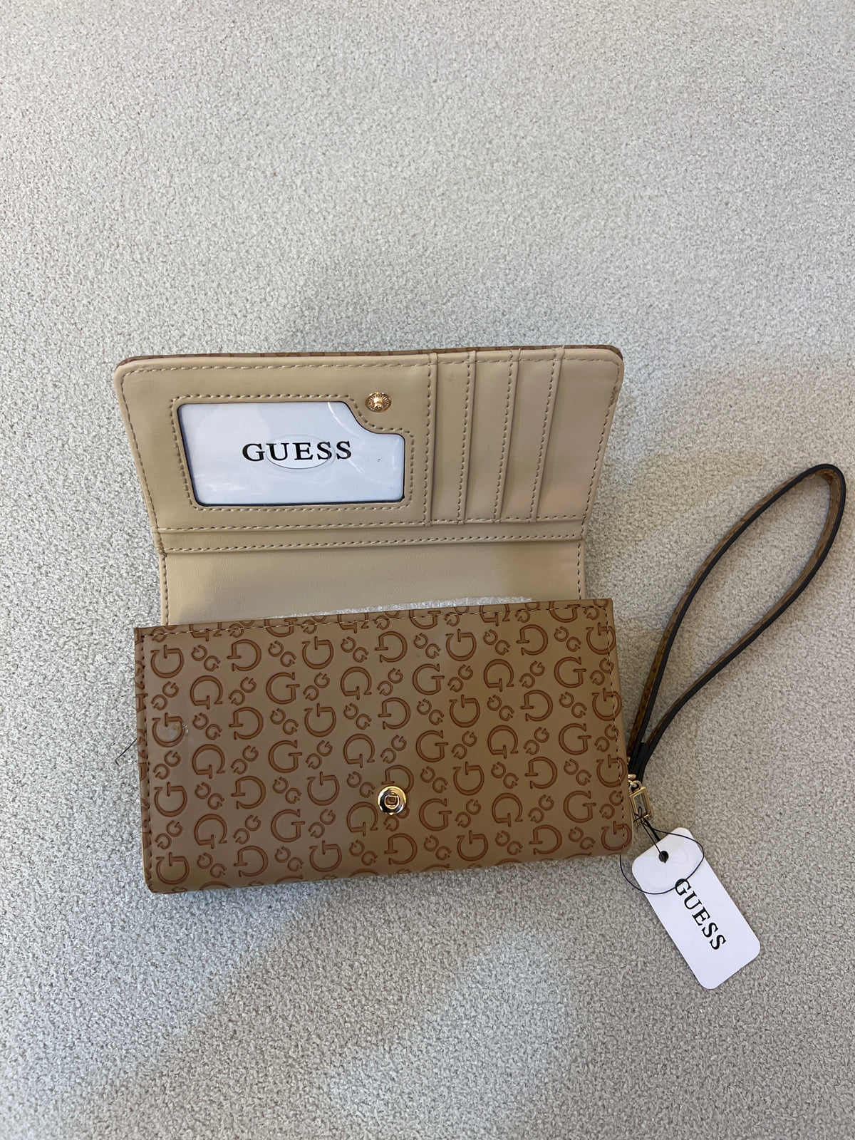 Guess Julie Phone Organizer Wallet, a brown faux-leather wristlet featuring an allover logo print and a gold-tone triangle logo on the front