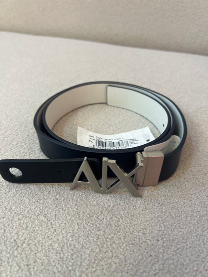 Armani Exchange belt is a reversible leather belt black and white featuring a prominent metallic logo hinge buckle
