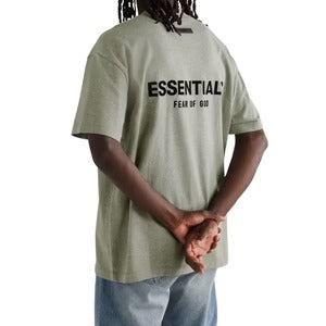 Fear of God Essentials t-shirt in a grey colorway, potentially "Light Oatmeal" or "Dark Oatmeal