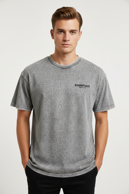 Fear of God Essentials t-shirt in a grey colorway, potentially "Light Oatmeal" or "Dark Oatmeal