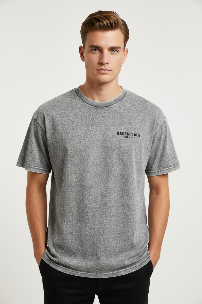 Fear of God Essentials t-shirt in a grey colorway, potentially "Light Oatmeal" or "Dark Oatmeal