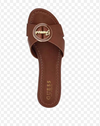 Guess brown slide sandals feature a distinctive gold-toned brand logo on the strap