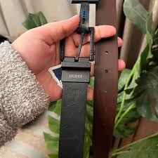 Guess brand reversible black and brown men's belt featuring a swivel buckle