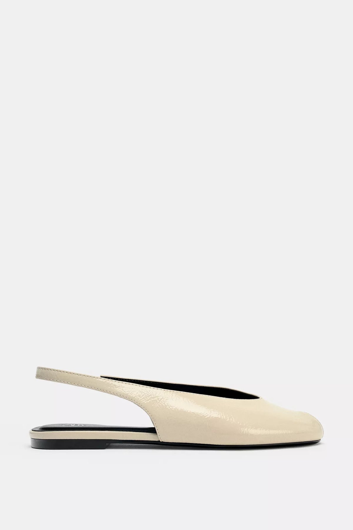 cream-colored Zara pointed-toe slingback flats feature a patent leather finish and an elasticated heel strap