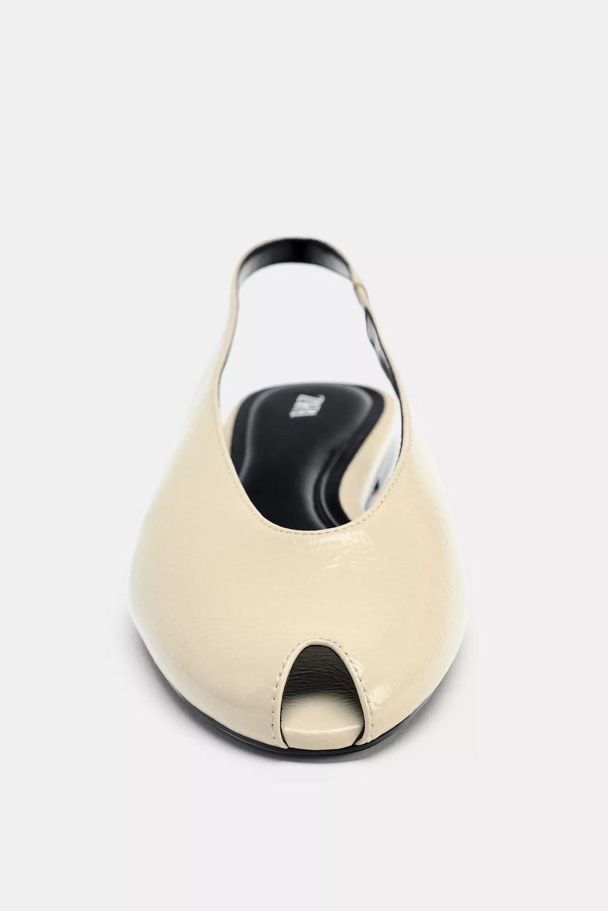 cream-colored Zara pointed-toe slingback flats feature a patent leather finish and an elasticated heel strap